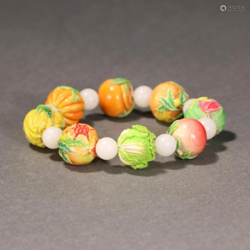 A CHINESE POLYCHROME VEGETABLES AND FRUITS BRACELET