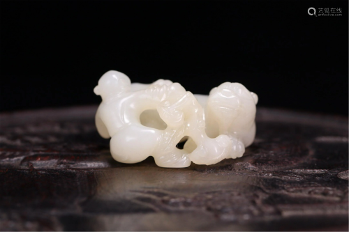 A CHINESE JADE CARVING OF CHILD AND MYTHICAL BEAST