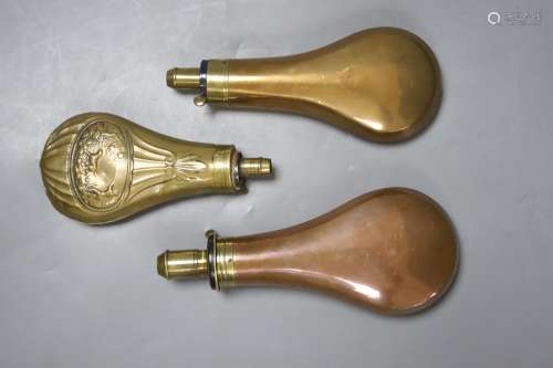 An 19th century embossed brass powder flask and two copper p...
