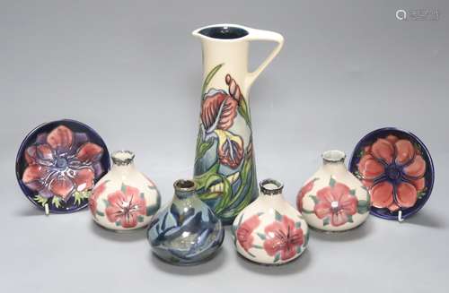 A Moorcroft iris pattern jug and two anenome dishes, togethe...