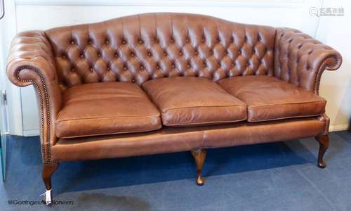 A George III style buttoned tan leather camel back sofa, 210...