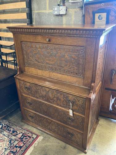 An Arts & Crafts oak escritoire, the cabinet was made out of...