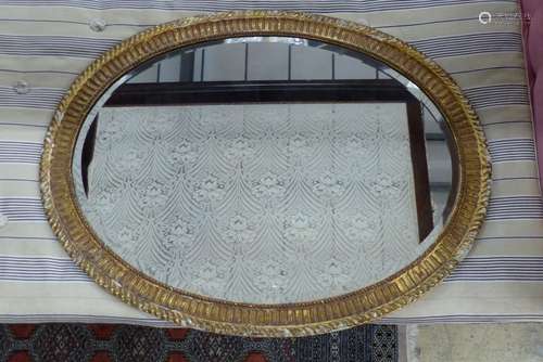 A large George III oval giltwood mirror, width 109cm, height...