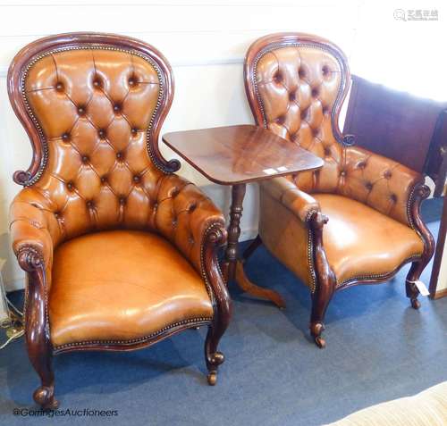 A pair of Victorian walnut and tan leather spoonback armchai...