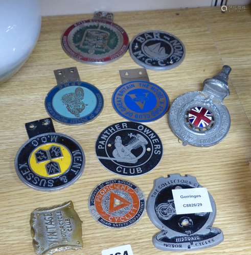 A small collection of car radiator caps and badges and motor...