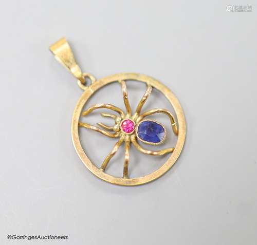 A 9ct, sapphire and ruby set circular spider pendant, 19mm, ...