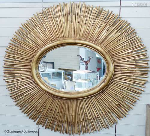 A large contemporary gilt oval 'sunburst' mirror, 145 cm wid...