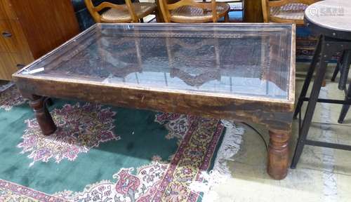 An Indian hardwood coffee table inset with a printing block,...