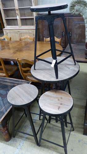 An adjustable wrought iron pub table and four matching teles...