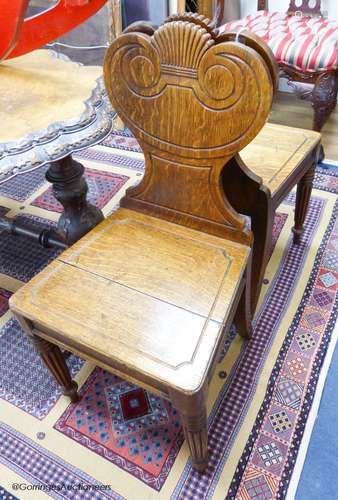 A pair of William IV oak hall chairs, stamped Gillows, Lanca...