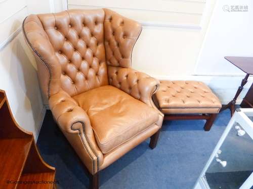 A pair of George III style buttoned tan leather wingback arm...