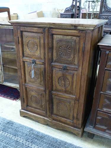 An Indian hardwood carved two door cabinet, width 77cm