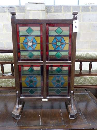 An Edwardian Liberty & Co. stained glass and beech leaded gl...