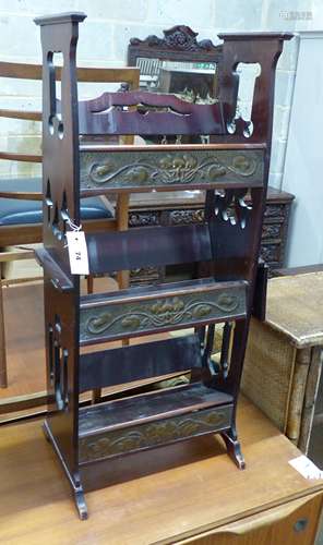 An Arts and Crafts brass inset mahogany book rack, width 43c...