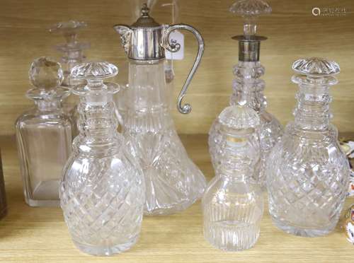 A silver mounted decanter, various other decanters, a claret...