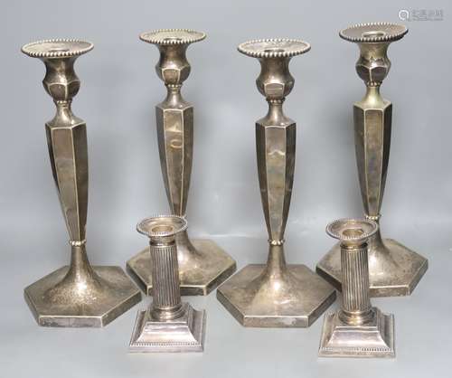 A set of 4 silver plated candlesticks and a pair of plated d...