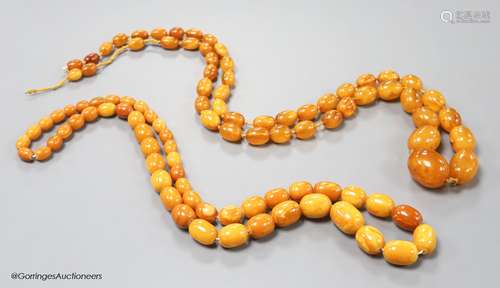 Two single strand graduated oval amber bead necklaces, 71cm,...