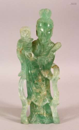 A CHINESE CARVED GREEN ROCK / JADE FIGURE OF A FEMALE FIGURE...