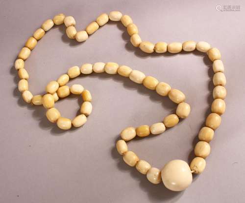 A LONG IVORY BEAD NECKLACE, comprising 62 barrel shaped bead...