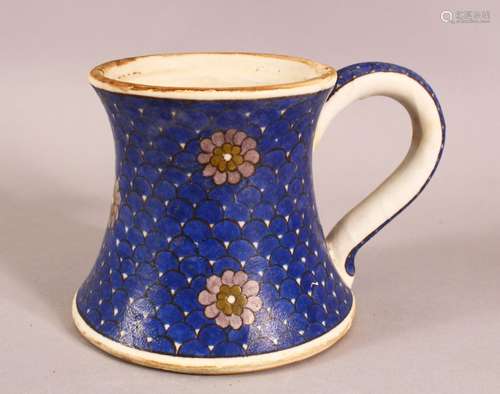 A TURKISH IZNIK POTTERY BLUE & WHITE CUP - decorated with fl...