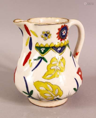 A TURKISH KUTAHYA POTTERY DECORATED JUG - decorated with mul...