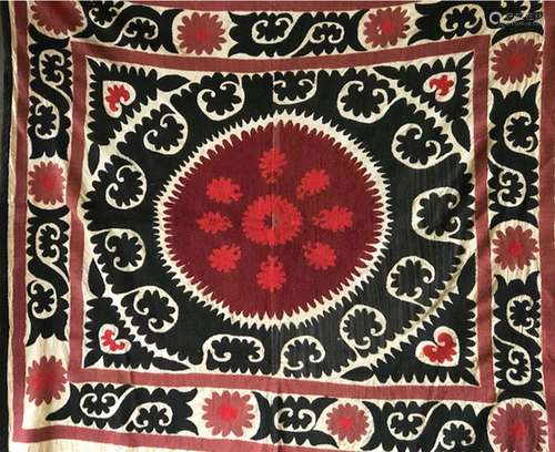 A HAND EMBROIDERED BLACK AND RED WALL COVERING / BEDSPREAD, ...