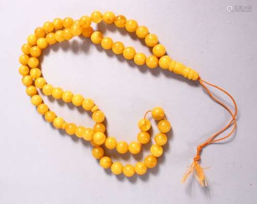 A CHINESE QING DYNASTY CARVED AMBER PRAYER BEADS / ROSARY NE...