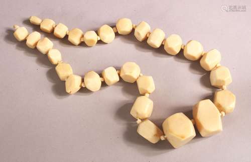 AN IVORY BEAD NECKLACE, comprising 26 facet beads, largest 3...