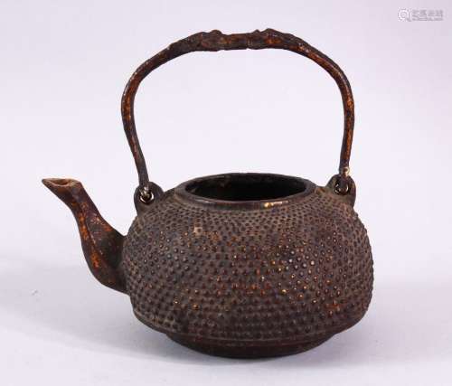 AN EARLY CHINESE BRONZE CIRCULAR KETTLE, with swing handle, ...
