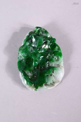 A CHINESE CARVED JADEITE PENDANT, 6cm x 4cm.