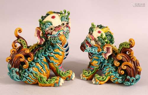 A PAIR OF 20TH CENTURY CHINESE SANCAI POTTERY LION DOGS - th...