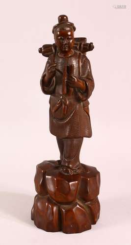 A 19TH CENTURY CHINESE CARVED WOODEN FIGURE OF A TRAVELLER, ...