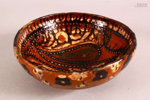 A SMALL PERSIAN BROWN GLAZED TERRACOTTA BOWL, the inner deco...