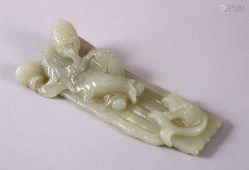 A CHINESE CARVED CELADON JADE FIGURE OF A RECLINED IMMORTAL ...
