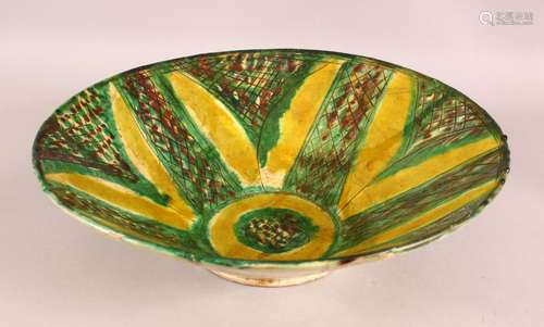 A LARGE NISHAPUR GREEN AND YELLOW GLAZED POTTERY BOWL, 37cm ...