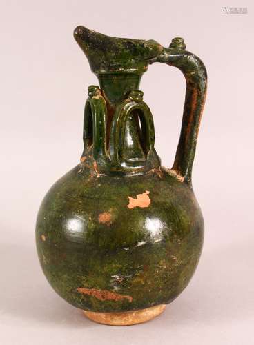 A GREEN GLAZED POSSIBLY UMAYYAD POTTERY EWER, the neck with ...