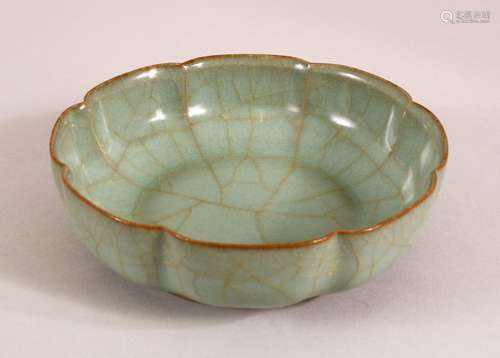 A CHINESE CELEDON SCALLOPED BOWL, the base with calligraphic...