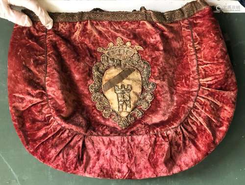 AN INTERESTING CRIMSON VELVET HANDBAG, applied with an earli...