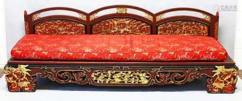 AN IMPRESSIVE CHINESE CARVED GILDED AND RED LACQUERED SETTEE...