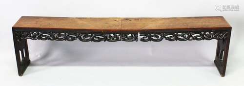 A CHINESE HARDWOOD BENCH SEAT with pierced and carved frieze...