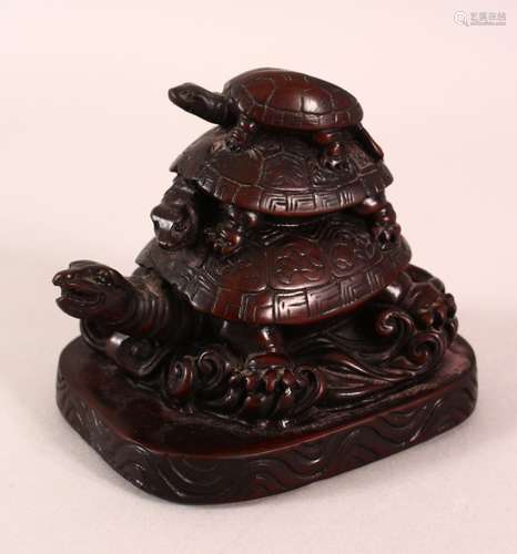 A CHINESE CARVED / MOULDED FIGURE OF THREE TURTLES AMONGST W...