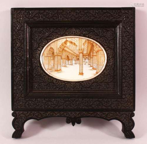 A GOOD INDIAN CARVED EBONY & PAINTED frame, the frame carved...