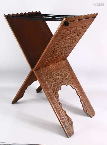 AN ISLAMIC CARVED WOODEN QURAN STAND - carved profusely with...