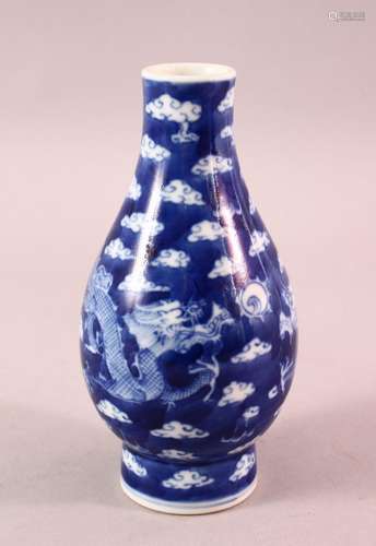 A CHINESE BLUE & WHITE PORCELAIN DRAGON VASE, with clouds an...