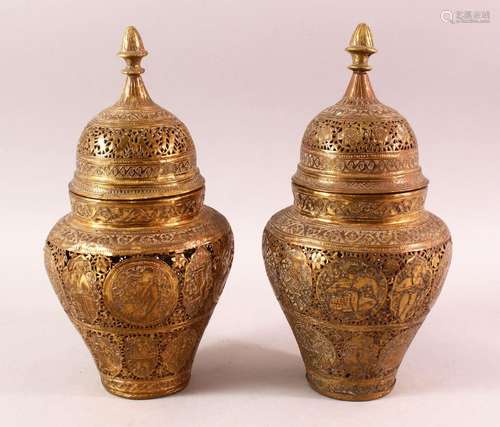 A PAIR OF QAJAR OPENWORK BRASS VASES & COVERS, with roundel ...