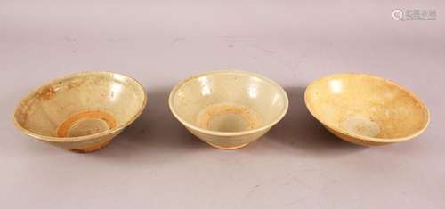 THREE EARLY CHINESE POTTERY BOWLS, of varying style and size...