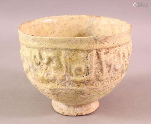 A KUFIC SCRIPT GLAZED POTTERY BOWL, the exterior with moulde...