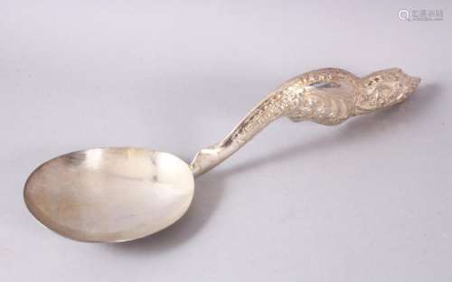 A LARGER BURMESE WHITE METAL MOULDED SERVING SPOON, the spoo...
