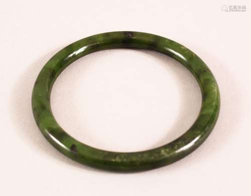 A CHINESE CARVED JADE BANGLE, 7.5cm