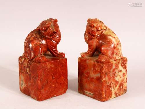 A PAIR OF CHINESE CARVED SOAPSTONE LION DOG SEALS - The pair...